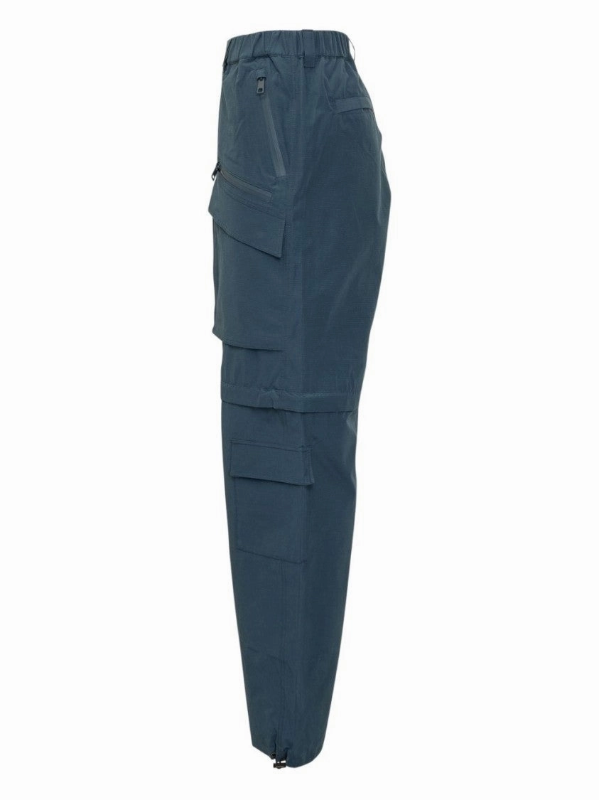 Steel Blue Trousers With Concealed Fastening And Zip Pockets